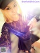 A woman in a black dress and a black hat.