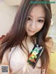A woman holding a cell phone with a pixelated design on it.