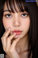 A close up of a woman's face with long black hair.